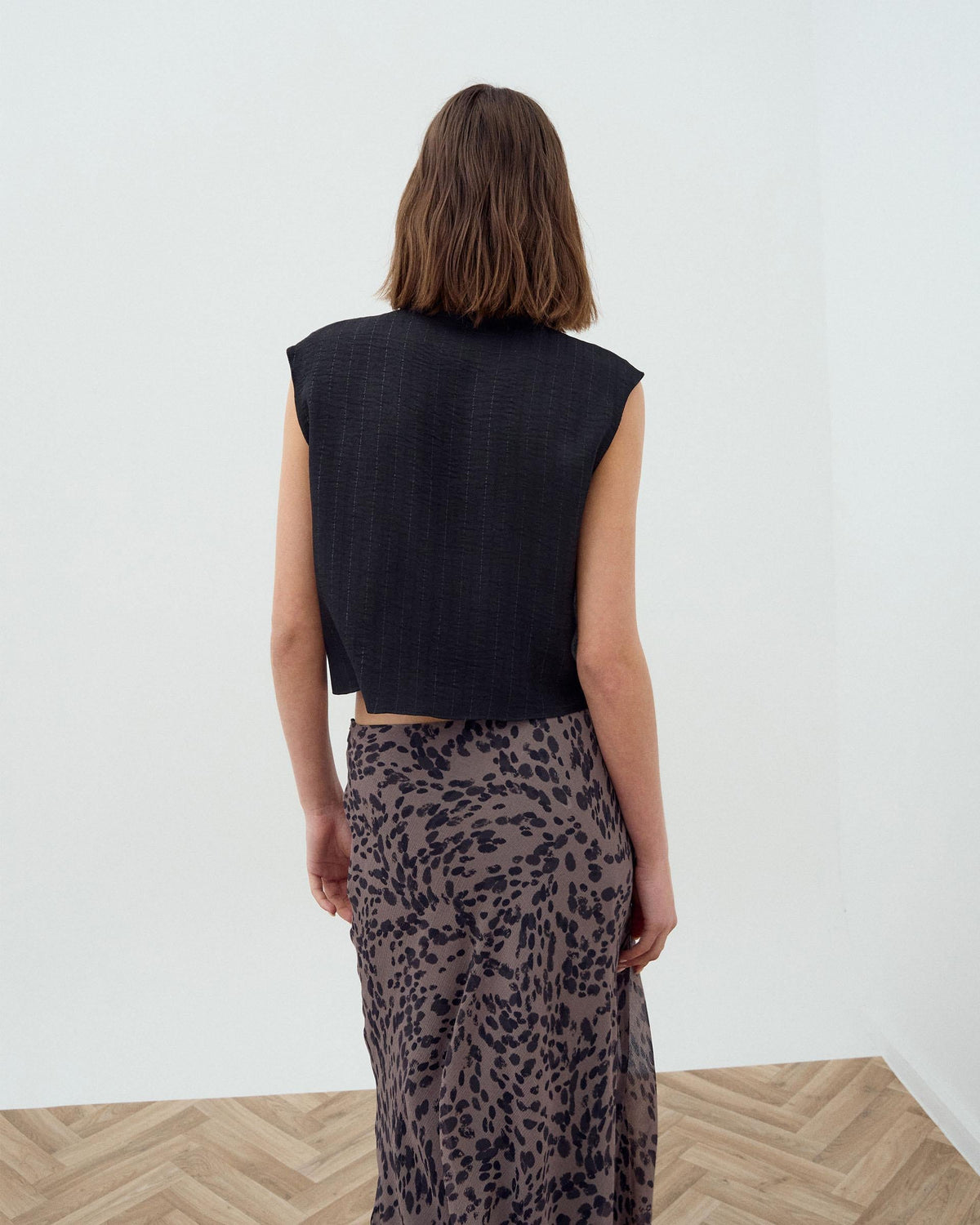 BLUSA SIN MANGAS BOTONES LATERALES RAYAS LUREX